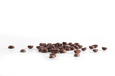 Coffee beans scattered on white background