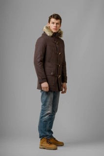 Full length portrait of handsome man in warm woolen coat posing in studio
