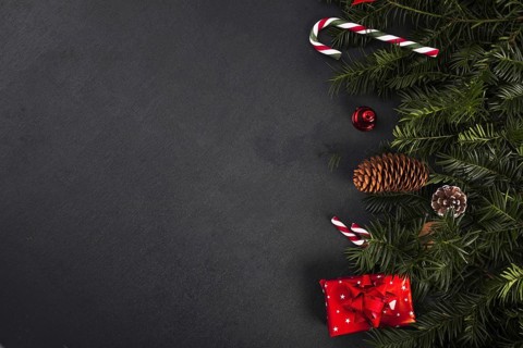 Fir twigs near candy canes gift box