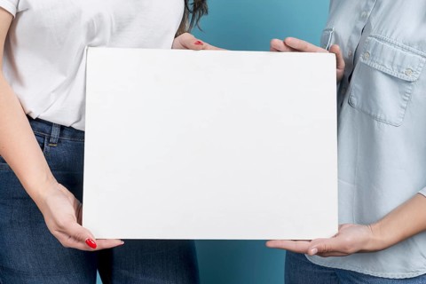 Girls holding blank board