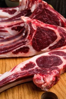 Close up view of fresh raw rack of lamb on cutting board
