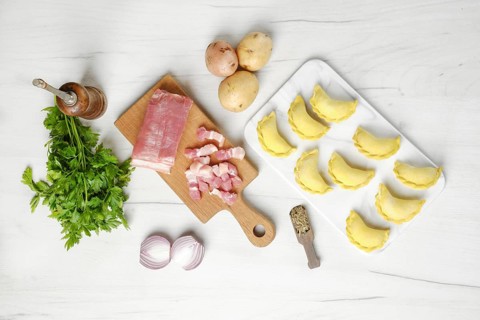 Top view of frozen dumplings with bacon and potato