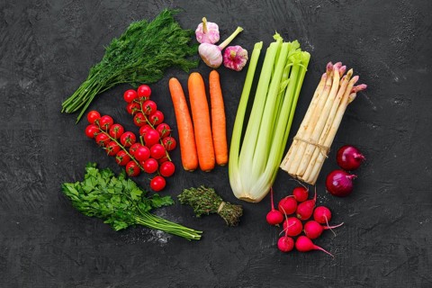 Top view of fresh raw vegetables on black background