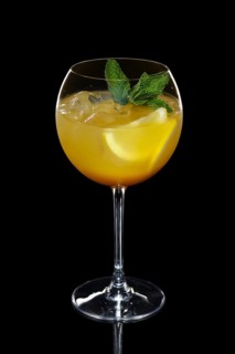 Cild lemon cocktail with a sparkling wine with ice in wine glass isolated on black