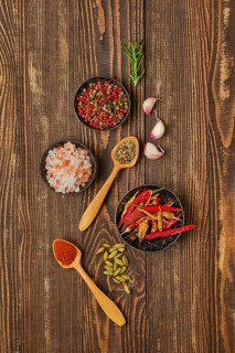 Overhead composition with spicy spice and seasonings on wooden background