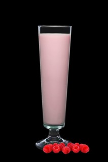 Tall glass of raspberry milk isolated on black background