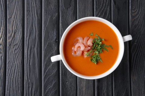 Top view of rustic tomato soup with shrimps