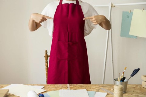 Woman pointing her red apron. Resolution and high quality beautiful photo