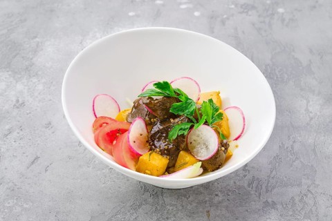 Portion of salad with fried chicken liver