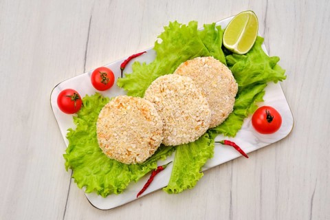 Top view of trout meat cutlet in breading