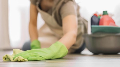 Close up woman cleaning floor