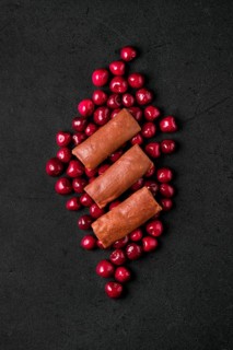 Overhead composition with thin chocolate pancakes stuffed with curd