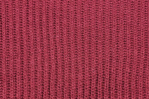Close up of knitted pattern on blue wool pullover