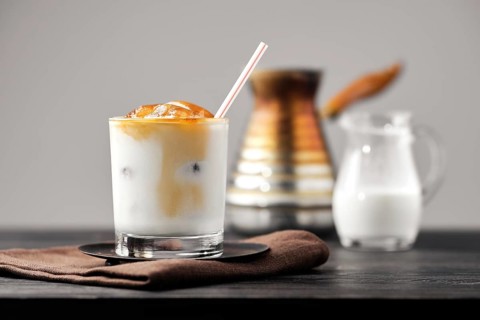 Iced latte with frozen coffee cubes and sweet cream