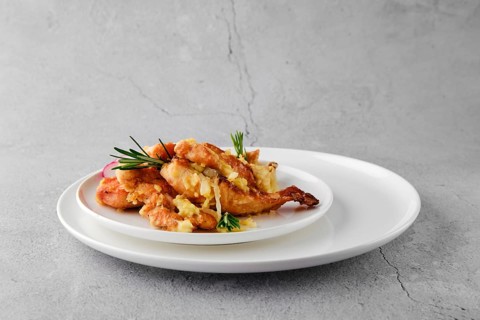 Plate with chicken stripes baked with cheese and onion