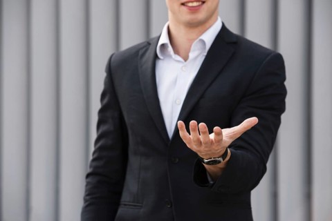 Front view businessman holding hand out