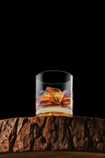 Bottom view at the glass with single malt whiskey with ice