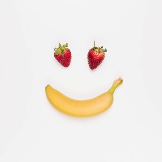 Red strawberry yellow banana white background