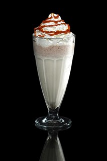Milkshake caramel summer cocktail isolated on black