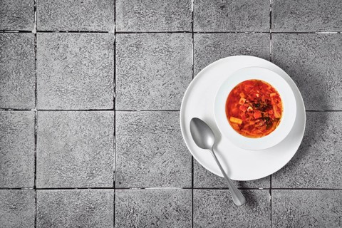 Overhead view of plate of soup with pulled beef and red bell pepper