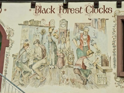 Clockmaker depicted in a facade painting of a Black Forest clock shop in Triberg