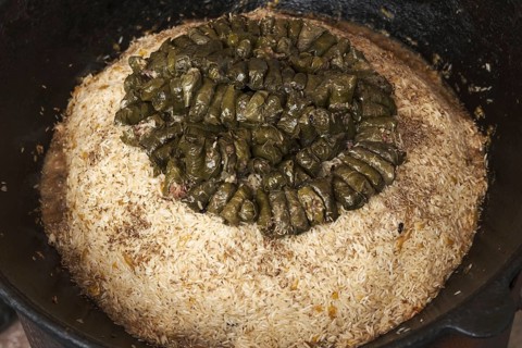Meat and dolma in cauldron. The making of pilaf
