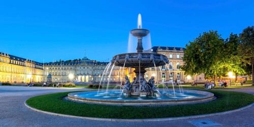 Schlossplatz with fountain and New Palace travelling panorama blue hour in Stuttgart