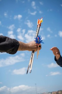 Hand holding old style wooden arrows