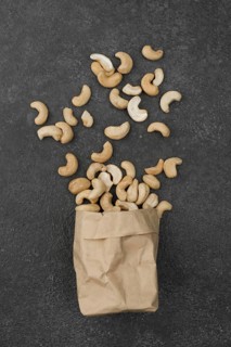 Paper bag filled with healthy raw cashew nuts. Resolution and high quality beautiful photo