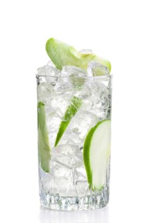 Glass of cold apple lemonade with ice isolated on white background