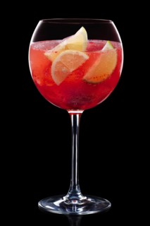 Cold sangria in a wine glass isolated on black