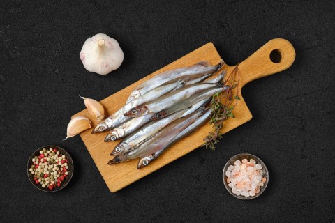 Top view of pile of fresh raw frozen capelin