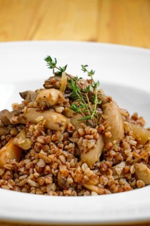 Close up view of boiled buckwheat with marinated mushrooms