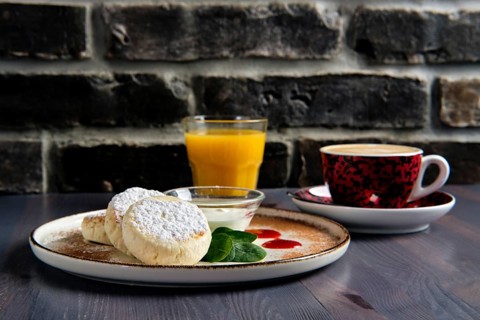Traditional breakfast with cottage cheese pancake with sour cream