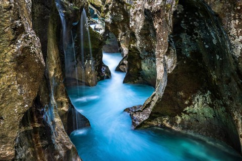 Mountain river Soca flows through narrow canyon