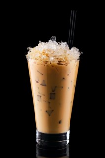 Milkshake with coffee and crushed ice isolated on black background