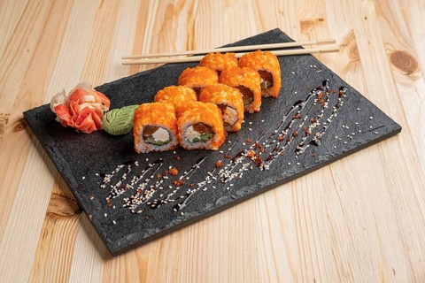 Set of rolls with wasabi and pickled ginger on stone serving board
