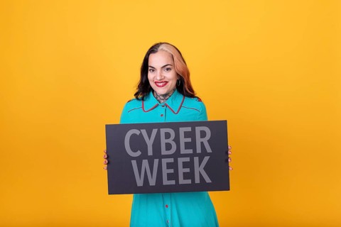 Beautiful woman holding a Cyber Week sign. Commercial concept. Commerce