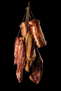 Assortment of air dried and smoked lamb and beef meat on hanger