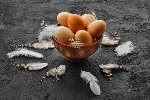 Fresh country eggs in clay bowl