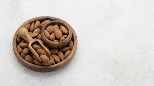 Organic almond nuts bowl copy space