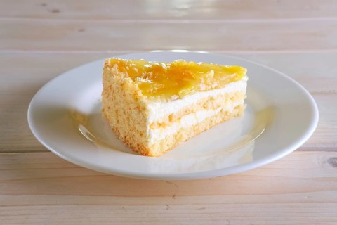 Layered orange cheesecake on plate