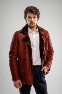 Brutal handsome unshaven man with beard and moustache in sheepskin coat with fur collar