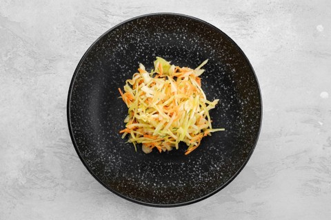 Pickled slices of cabbage and carrot on a plate