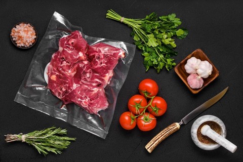 Vacuum sealed lamb neck meat with ingredients for cooking
