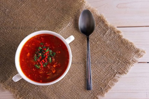 Top view of plate of gazpacho on wooden table