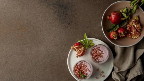 Flat lay yogurt with pomegranate copy space