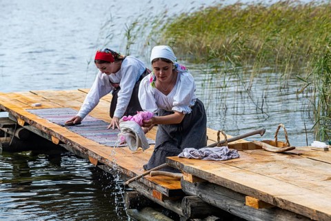 Traditionla dressed women doing hand washing