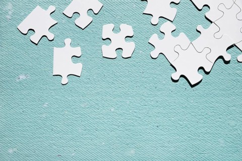 White jigsaw puzzle piece blue textured surface. Resolution and high quality beautiful photo