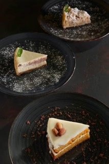 Three pieces of homemade cakes on a dark wooden vintage background